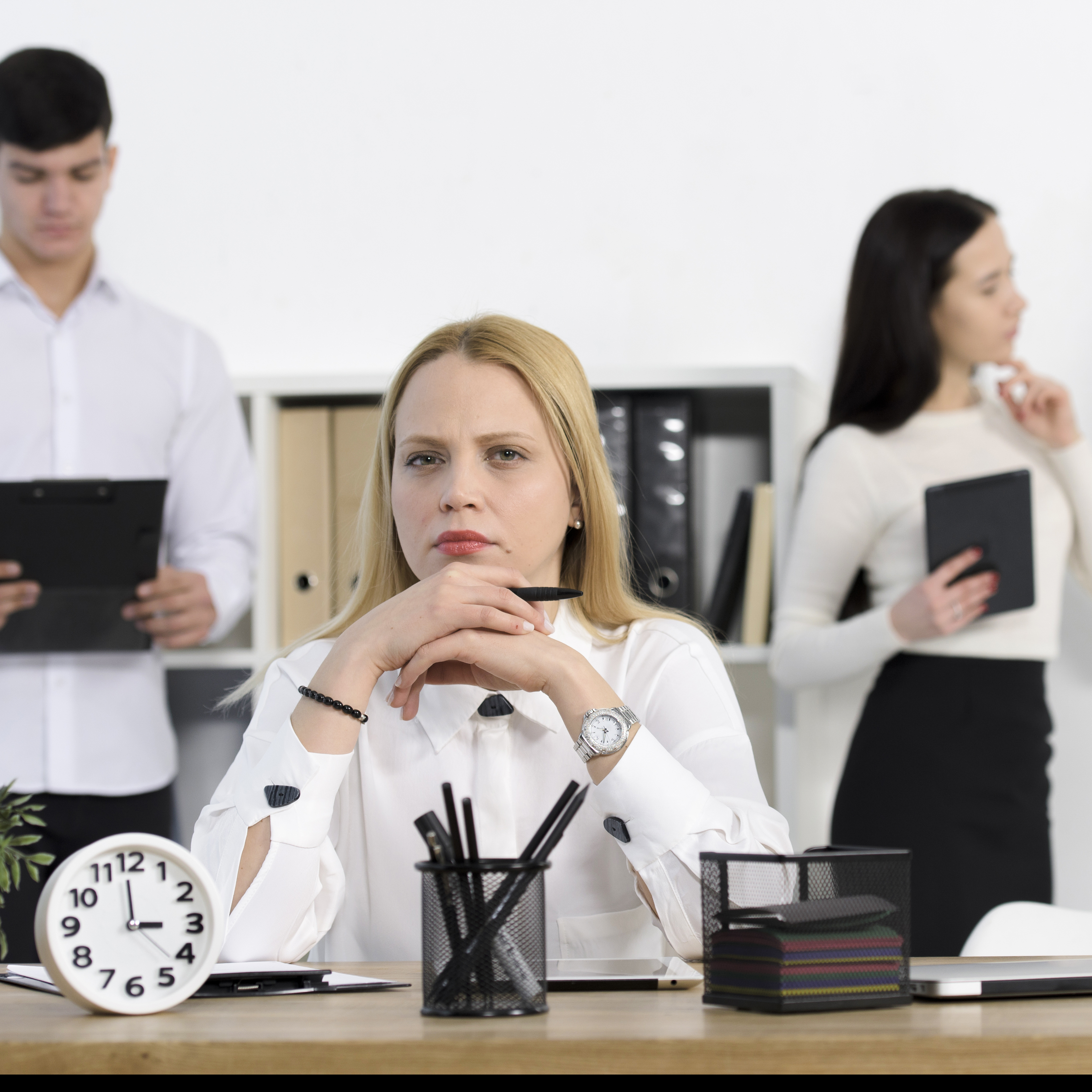 colleague-standing-serious-young-businesswoman-workplace.jpg